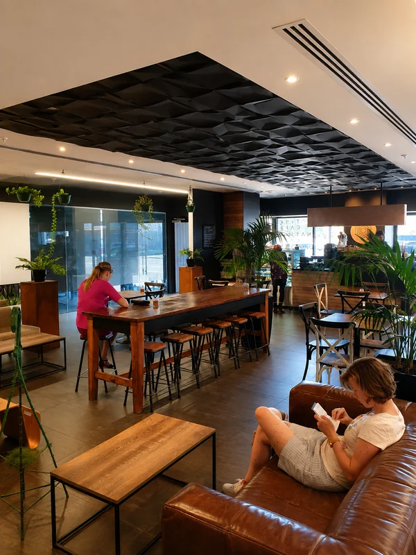 Tables, plants and seating looking towards the Native coffee counter